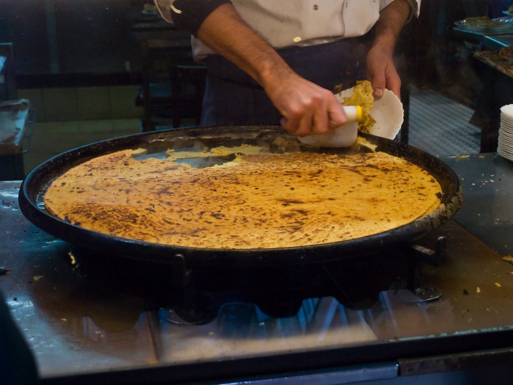 When it comes to street food in France, you need to try Socca.