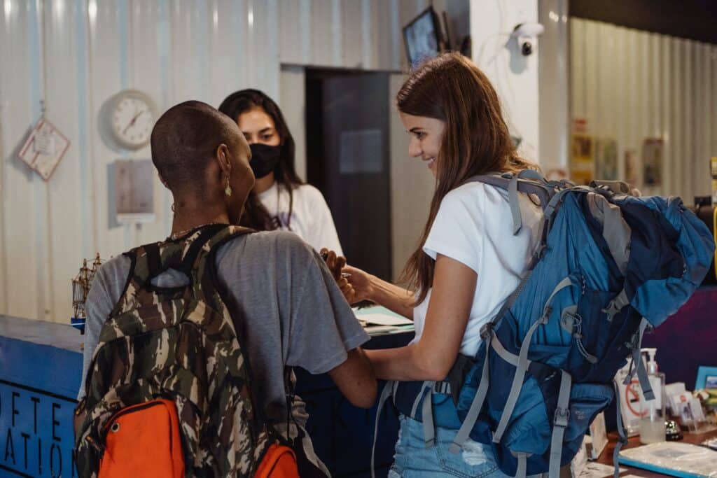 Women Checking in and Picking up Keys for the Hotel Room. It accompanies one of our tips for backpackers in South America.