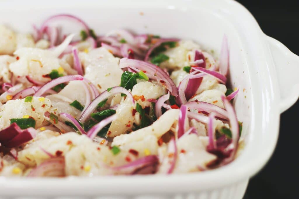 A close-up of a bowl of ceviche. It accompanies one of our tips for backpackers in South America.