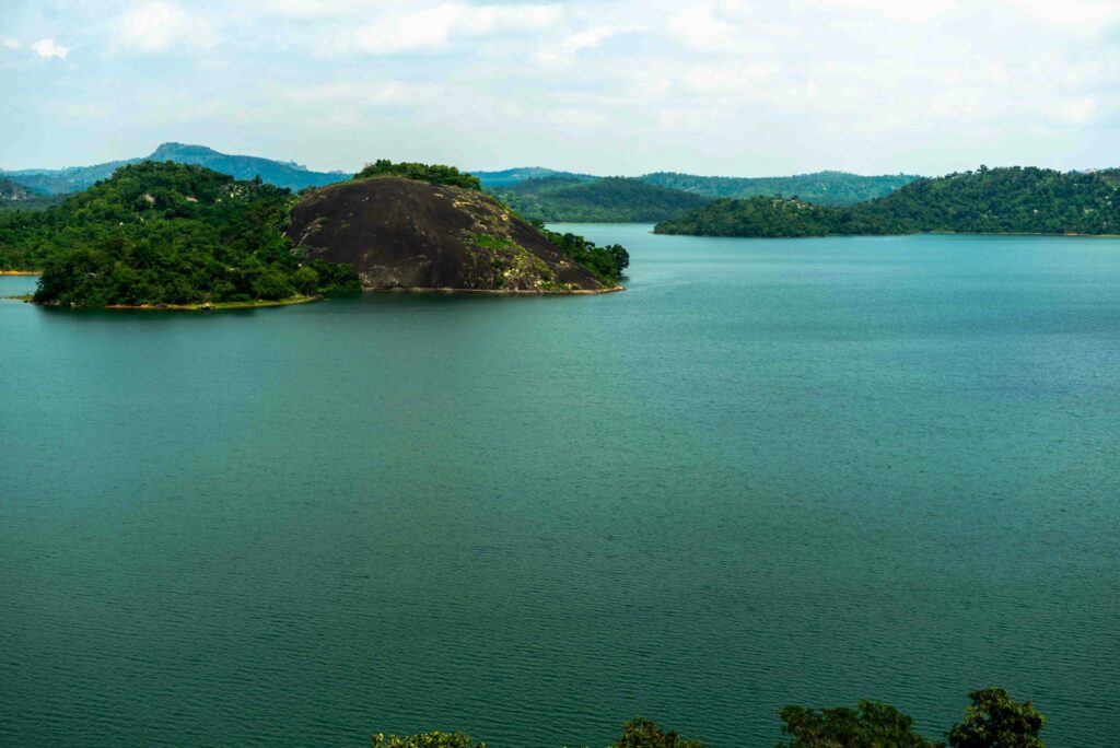 A breathtaking landscape showcasing the natural beauty of Nigeria, with lush greenery, rolling hills surrounded by a water body. Nigeria should be your next adventure for its awe-inspiring scenery and countless exploration opportunities.