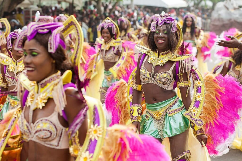 Dancers dressed in bright yellow, purple, pink, and green dresses to celebrate Calabar Carnival. The country's cultural celebration are another reason why Nigeria should be your next adventure.