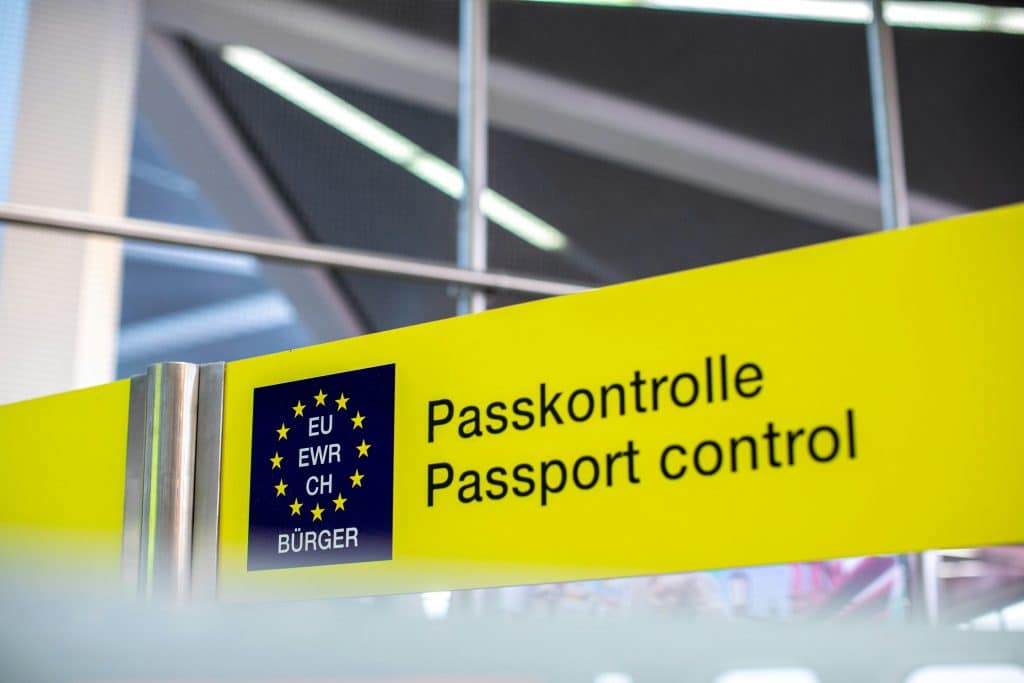 An image of a passport control sign that is typically displayed at passport control checkpoints.