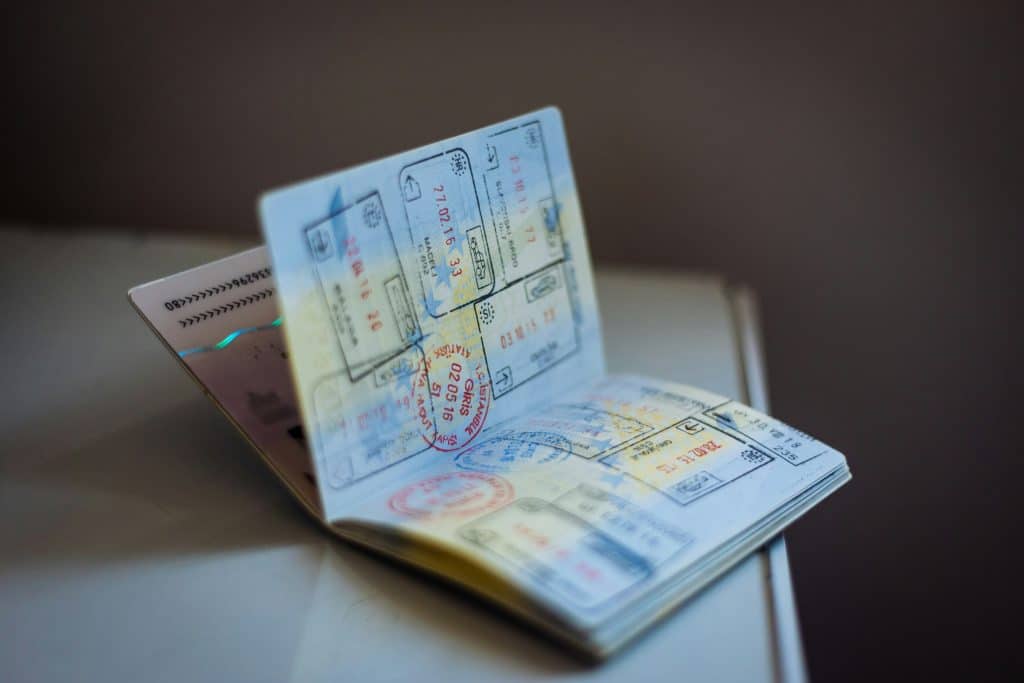 An open international passport displaying visa stamps from various countries, highlighting the global travel opportunities with a passport