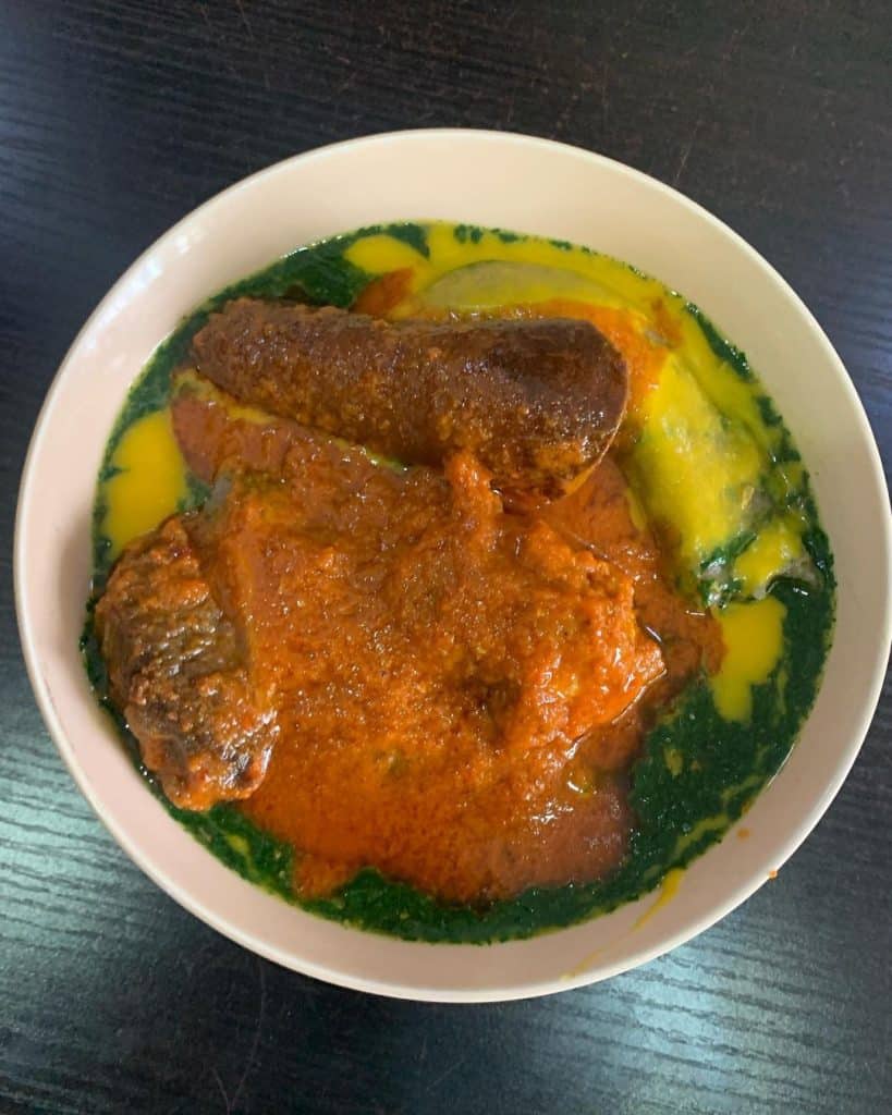 An appetizing bowl of Gbegiri Soup, a traditional Nigerian soup made from puréed beans, typically served with assorted meats and enjoyed for its rich flavor and creamy texture.