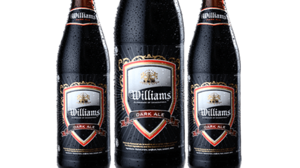 Three bottles of Williams Dark Ale against a white background.